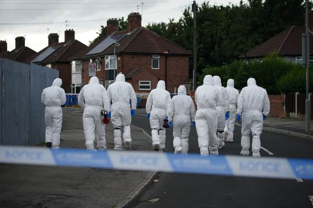 Forensic officers near to the scene in Kingsheath Avenue, Knotty Ash, Liverpool, where a nine-year-old girl has been fatally shot. Credit: PA