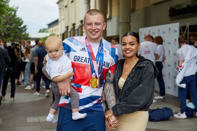Adam Peaty poses for a photograph with Eirianedd Munro and their son George-Anderson Peaty during the National Lottery’s event celebrating “our greatest swim team”  at Sheraton Heathrow Hotel on August 02, 2021 in London, England. (Photo by Karl Bridgeman/Getty Images for The National Lottery)