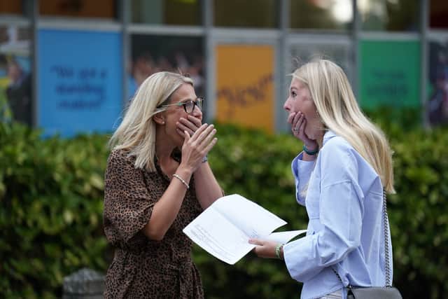 Maddie Hallam with her mother receiving her GCSE results at Norwich School, in Norwich, Norfolk. Credit: PA