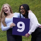 Molly Fearn and Aminah Majid celebrate after receiving their GCSE results at The Grammar School in Leeds, Yorkshire. Credit: PA