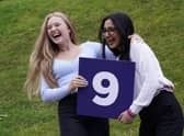 Molly Fearn and Aminah Majid celebrate after receiving their GCSE results at The Grammar School in Leeds, Yorkshire. Credit: PA