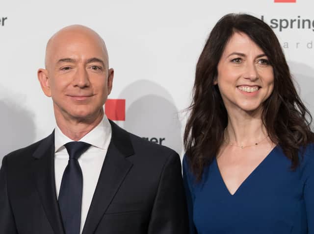Amazon CEO Jeff Bezos and his wife MacKenzie Bezos  poses as they arrive at the headquarters of publisher Axel-Springer where he will receive the Axel Springer Award 2018 on April 24, 2018 in Berlin. (Photo by JORG CARSTENSEN / dpa / AFP)
