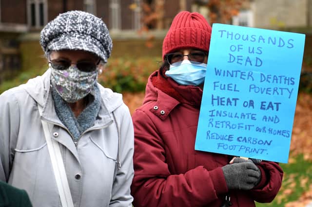 Protestors hold a placard highlighting the excess winter deaths caused by fuel poverty, at the George V statue, Old Palace Yard in Westminster, London (Pic: AFP via Getty Images)