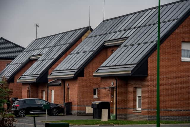 Solar panels installed on roofs of houses in Loos-en-Gohelle, northern France, on November 25, 2016. (Photo by PHILIPPE HUGUEN/AFP via Getty Images)