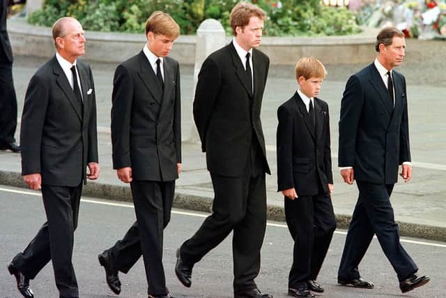 (L to R) The Duke of Edinburgh, Prince William, Earl Spencer, Prince Harry and Prince Charles walk outside Westminster Abbey during the funeral service for Diana, Princess of Wales, 06 September (Photo by JEFF J. MITCHELL/AFP via Getty Images)