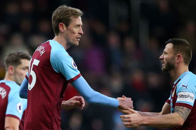 Peter Crouch of Burnley shakes hands with Phillip Bardsley of Burnley during the Premier League match between Burnley FC and Southampton FC at Turf Moor on February 2, 2019 in Burnley, United Kingdom.  (Photo by Alex Livesey/Getty Images)