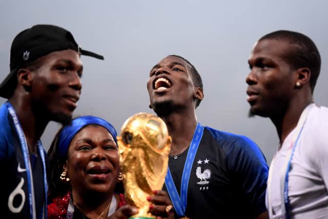 Florentin (l), Pogba’s mother, Paul (c) and Mathias (r) after France won the 2018 World Cup