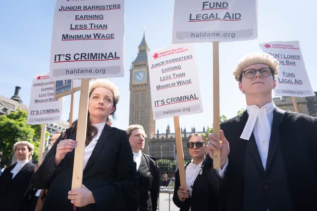 Criminal defence barristers outside the Houses of Parliament in London.