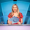 Victoria Coren Mitchell, wearing a red polka dot dress, behind the desk presenting Only Connect (Credit: BBC/Parasol Media Limited/Rory Lindsay)