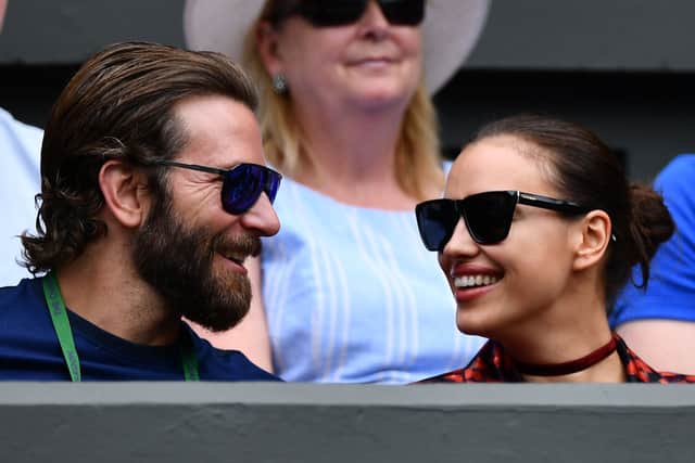 US actor Bradley Cooper and Russian model Irina Shayk sit in centre court before the men’s semi-final match on the twelfth day of the 2016 Wimbledon Championships, London, on July 8, 2016. (Photo credit should read LEON NEAL/AFP via Getty Images)