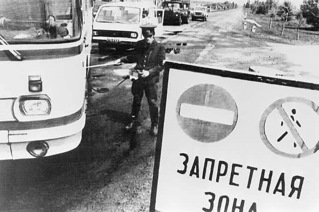 A policeman checks the level of radioactivity on vehicles leaving the 30 km forbidden area around Chernobyl after the nuclear plant No. 4 reactor’s blast, 26 April 1986, the world’s worst nuclear accident of the 20th century. (STF/AFP via Getty Images)