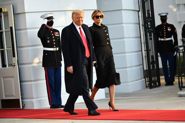 Donald Trump and Melania make their way to board Marine One before departing from the South Lawn of the White House in Washington, DC on January 20, 2021 (Photo by MANDEL NGAN/AFP via Getty Images)