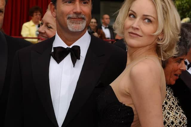 US actress Sharon Stone (R) and her husband Phil Bronstein as they arrive at the 74th Annual Academy Awards at the Kodak Theatre in Hollywood, California 24 March 2002. It was announced 03 July 2003 that Stone has split from her husband of five years. The star of "Basic Instinct" separated from newspaper editor Phil Bronstein after recently completing a new film in London.  AFP PHOTO/Lucy NICHOLSON (Photo credit should read LUCY NICHOLSON/AFP via Getty Images)