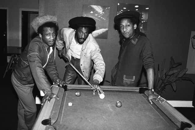 Aswad (Brinsley Forde, Tony Robinson and Angus Gaye), British reggae band, pictured playing pool, 8th March 1984. Drummie Zeb’s death was announced in September 2022. He was 62 years old. 