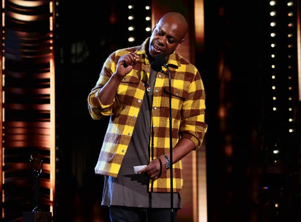 CLEVELAND, OHIO - OCTOBER 30: Dave Chappelle speaks onstage during the 36th Annual Rock & Roll Hall Of Fame Induction Ceremony at Rocket Mortgage Fieldhouse on October 30, 2021 in Cleveland, Ohio. (Photo by Dimitrios Kambouris/Getty Images for The Rock and Roll Hall of Fame )