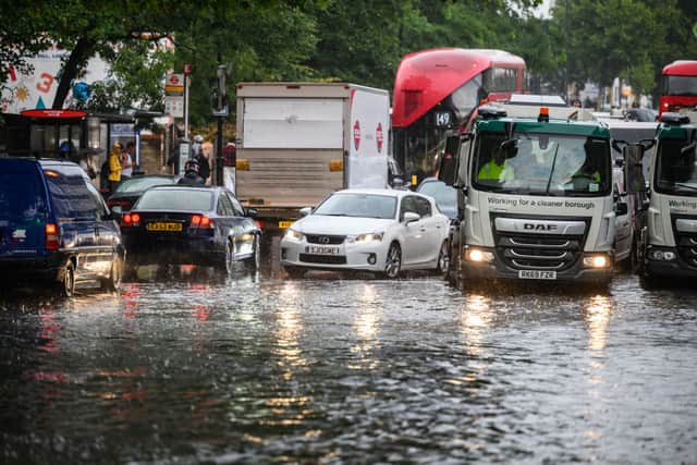 A car negotiates a flooded section of road, as torrential rain and thunderstorms hit the country on August 17, 2022 in London, England. (Photo by Leon Neal/Getty Images)