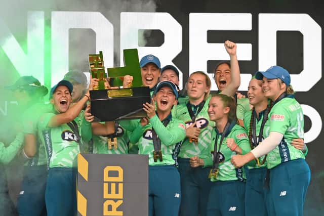 The Oval Invincibles celebrate victory with the trophy after The Hundred Final match between Southern Brave Women and Oval Invincibles Women at Lord's 