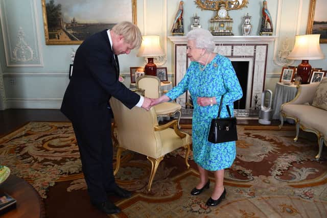 Mr Johnson bows to the Queen when she invited him to become Prime Minister in July 2019. Credit: Getty Images