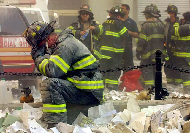 Firefighter Gerard McGibbon, of Engine 283 in Brownsville, Brooklyn, prays after the World Trade Center buildings collapsed September 11, 2001 (Photo by Mario Tama/Getty Images)