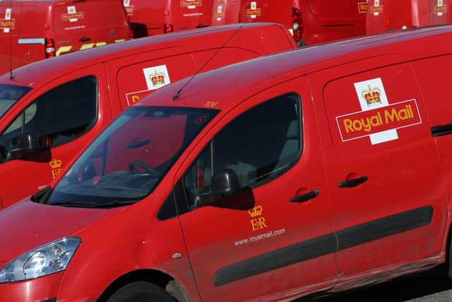 Royal Mail vehicles are parked outside the Basingstoke delivery office on August 26, 2022 during a strike over pay (Photo by ADRIAN DENNIS/AFP via Getty Images)