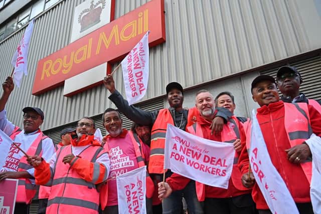Royal Mail postal workers hold placards and chant slogans as they stand on a picket line outside a delivery office, in north London, on September 8, 2022 during a strike (Photo by JUSTIN TALLIS/AFP via Getty Images)