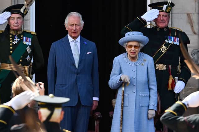 Prince Charles and Queen Elizabeth II attend the Royal Company of Archers Reddendo Parade in the gardens of the Palace of Holyroodhouse on June 30, 2022 in Edinburgh, United Kingdom (Photo by Jeff J Mitchell/Getty Images)