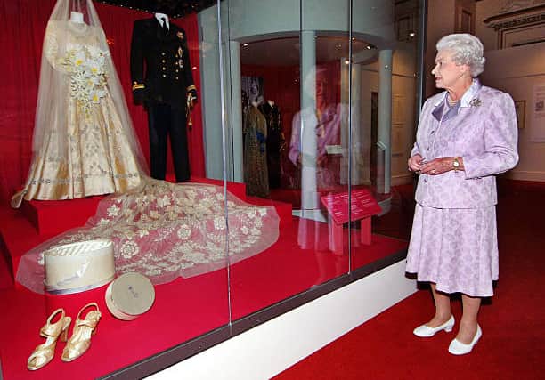 The Queen remarks at her couture wedding dress that had a 13-foot train (Pic:Getty)