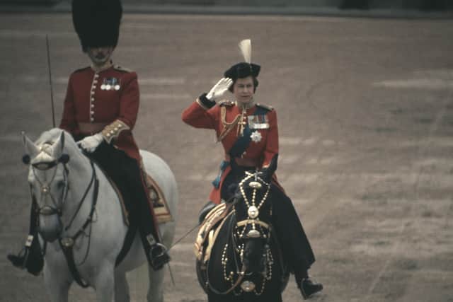 Queen Elizabeth II sits astride her horse Burmese as she makes her way from Buckingham Palace along the Mall to Horse Guards Parade during the Trooping the Colour ceremony on the Queen's official Birthday Parade in London, UK, 12th June 1971. (Photo by Steve Wood/Daily Express/Hulton Archive/Getty Images)