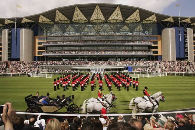 Queen Elizabeth II arrives in a horse drawn carriage to officially open the new grandstand on first day of Royal Ascot, at the Ascot Racecourse on June 20, 2006 in Ascot, England. The event has been one of the highlights of the racing and social calendar since 1711, and the royal patronage continues today with a Royal Procession taking place in front of the grandstands daily.  (Photo by Scott Barbour/Getty Images)