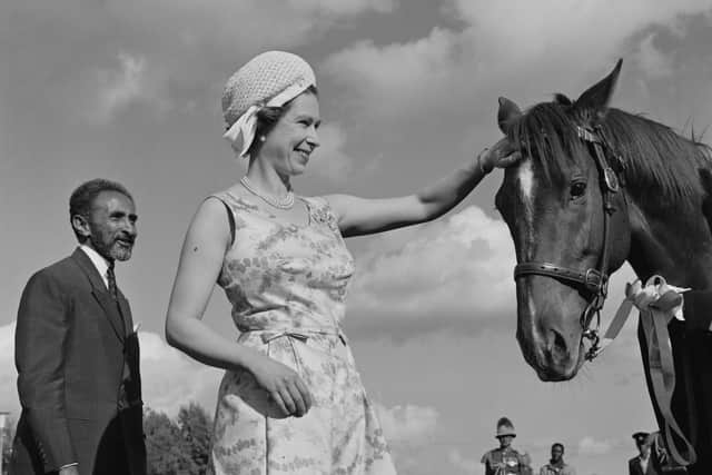 Queen Elizabeth II patting on the forehead of a horse while Ethiopian emperor Haile Selassie (1892 - 1975) is standing next to her during her visit to Ethiopia, 5th February 1965. (Photo by Terry Fincher/Daily Express/Hulton Archive/Getty Images)