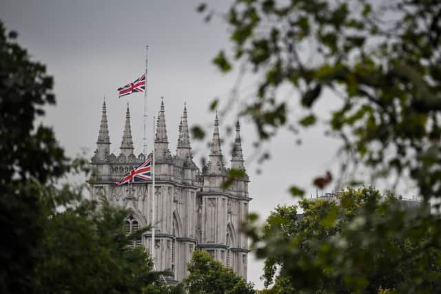 A Union flag flies at half-mast at the top of Westminster Abbey, on September 9, 2022, a day after Queen Elizabeth II died at the age of 96. - Queen Elizabeth II, the longest-serving monarch in British history and an icon instantly recognisable to billions of people around the world, died at her Scottish Highland retreat on September 8. (Photo by Ben Stansall / AFP) (Photo by BEN STANSALL/AFP via Getty Images)