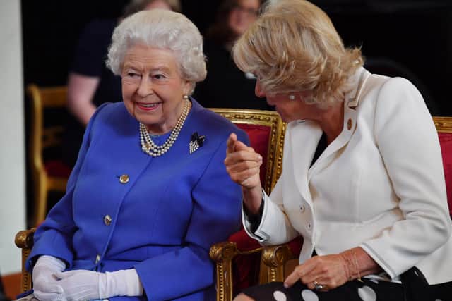 Queen Elizabeth II speaks with  Camilla, Duchess of Cornwall as they  watch a demonstration by dogs of the charity Medical Detection Dogs during the 10th Anniversary celebration of the charity at The Royal Mews on June 6, 2018 in London, England. (Photo by Ben Stansall - WPA Pool/Getty Images)