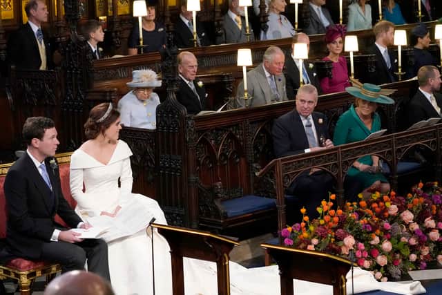 Princess Eugenie and her husband Jack Brooksbank, look back towards the Duke of York and Sarah, Duchess of York (seated front) and Queen Elizabeth II, the Duke of Edinburgh, Prince of Wales, the Duke and Duchess of Cambridge, and the Duke and Duchess of Sussex, during their wedding at St George's Chapel in Windsor Castle on October 12, 2018 in Windsor, England. (Photo by Danny Lawson - WPA Pool/Getty Images)
