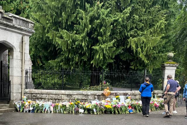 Floral tributes left by mourners at the gates of Balmoral.