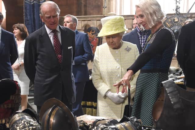 Queen Elizabeth II and Prince Philip, The Duke of Edinburgh view some of the props on the set of Game of Thrones in Belfast’s Titanic Quarter. (Photo by Aaron McCracken/Harrison Photography via Getty Images)