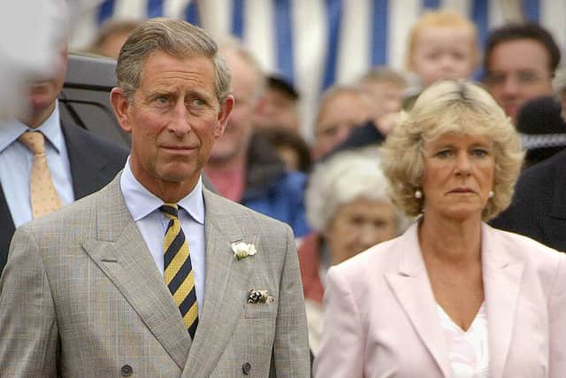 Prince Charles and Camilla Parker Bowles stand for the British National Anthem as they arrive for the Sandringham Flower Show on the Royal Sandringham Estate July 31, 2002 in Norfolk, England (Photo by Sion Touhig/Getty Images)