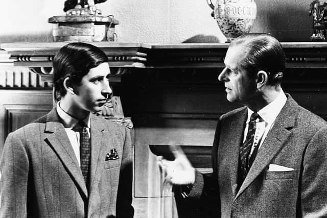 Prince Charles (left) talking to his father, the Duke of Edinburgh, in front of a fireplace at Sandringham, Scotland, 1969. (Photo by Central Press/Hulton Archive/Getty Images)