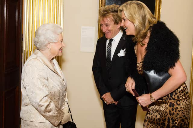 Queen Elizabeth II with Sir Rod Stewart and wife Penny Lancaster after he was awarded a knighthood in recognition of his services to music and charity. (Photo by Jeff Spicer - WPA Pool/Getty Images)
