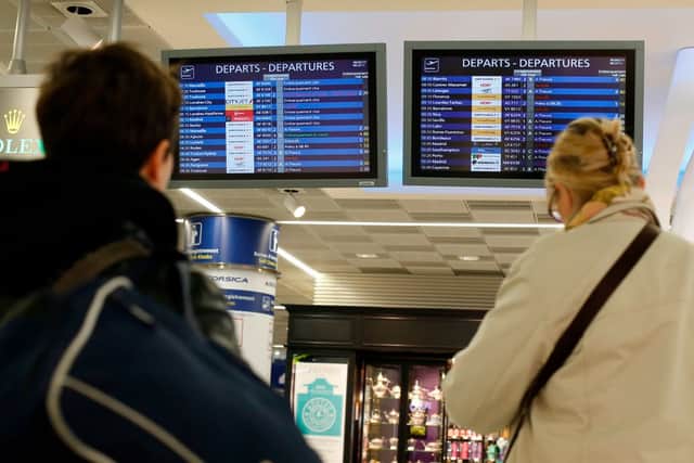 Passengers look at departures boards, on April 8, 2015 at Orly airport, outside Paris, as hundreds of flights to and from France were expected to be cancelled today as air traffic controllers launched a two-day strike over working conditions (Photo by THOMAS SAMSON/AFP via Getty Images)