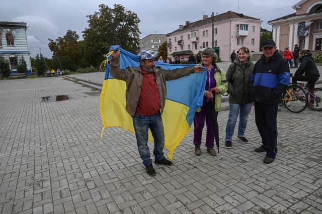 Kharkiv residents wave the Ukrainian flag following the counter-offensive. (Credit: Getty Images)