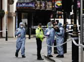 Forensics officers and police at the scene in Shaftesbury Avenue, central London, where two police officers were stabbed by a man around 6am. Credit: PA