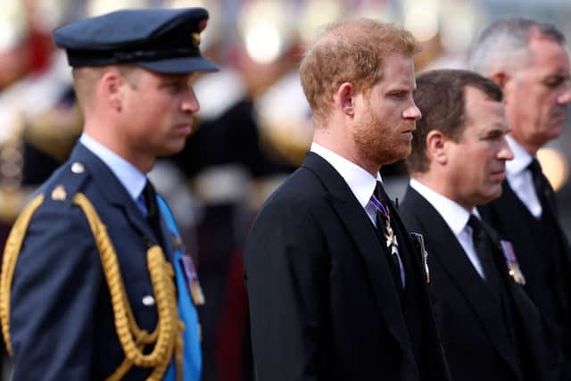 Britain's Prince William, Prince of Wales, Britain's Prince Harry, Duke of Sussex and Peter Phillips, walk behind the coffin of Queen Elizabeth II