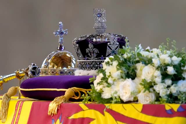 The Imperial State Crown and the Sovereign’s orb and sceptre lie on top of the Queen’s coffin (Pic: Getty Images)