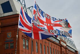 GLASGOW, SCOTLAND - SEPTEMBER 17:  A general view as a flag outside Ibrox stadium displays a tribute to Her Majesty Queen Elizabeth II, who died at Balmoral Castle on September 8, 2022, during the Cinch Scottish Premiership match between Rangers FC and Dundee United at  on September 17, 2022 in Glasgow, Scotland. (Photo by Mark Runnacles/Getty Images)