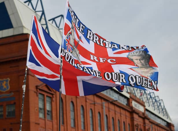 <p>GLASGOW, SCOTLAND - SEPTEMBER 17:  A general view as a flag outside Ibrox stadium displays a tribute to Her Majesty Queen Elizabeth II, who died at Balmoral Castle on September 8, 2022, during the Cinch Scottish Premiership match between Rangers FC and Dundee United at  on September 17, 2022 in Glasgow, Scotland. (Photo by Mark Runnacles/Getty Images)</p>