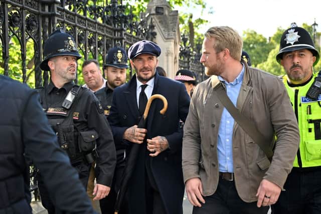 English former football player David Beckham leaves Westminster Hall, at the Palace of Westminster, in London on September 16, 2022 after paying his respects to the coffin of Queen Elizabeth II (Photo by LOUISA GOULIAMAKI/AFP via Getty Images)