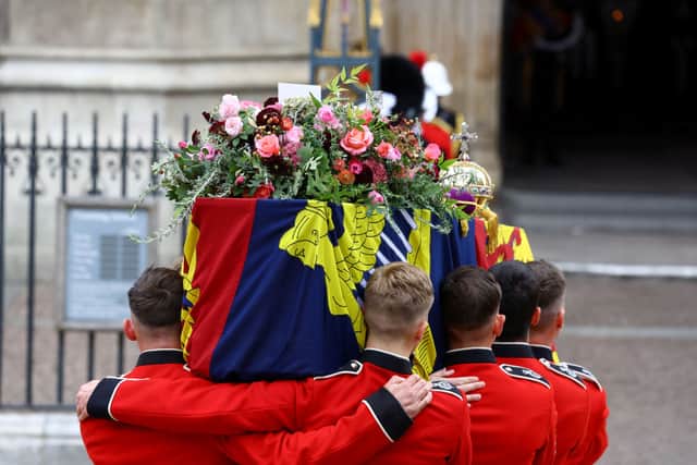 The coffin of Britain’s Queen Elizabeth is carried into the Westminster Abbey during the state funeral and burial of Queen Elizabeth II at Westminster Abbey on September 19, 2022 in London, England. (Photo by Hannah McKay- WPA Pool/Getty Images)