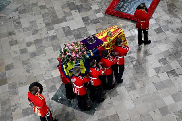 The coffin of Queen Elizabeth II with the Imperial State Crown resting on top is carried by the Bearer Party into Westminster Abbey during the State Funeral of Queen Elizabeth II on September 19, 2022 in London, England (Photo by Gareth Cattermole/Getty Images)