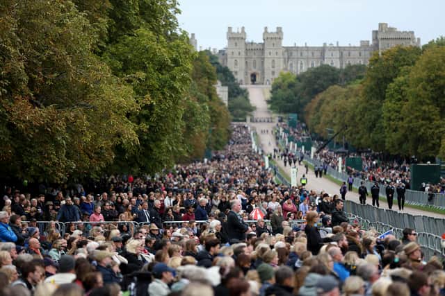 Members of the public watch the State funeral of Queen Elizabeth II on big screens on the Long walk (Pic: Getty Images)
