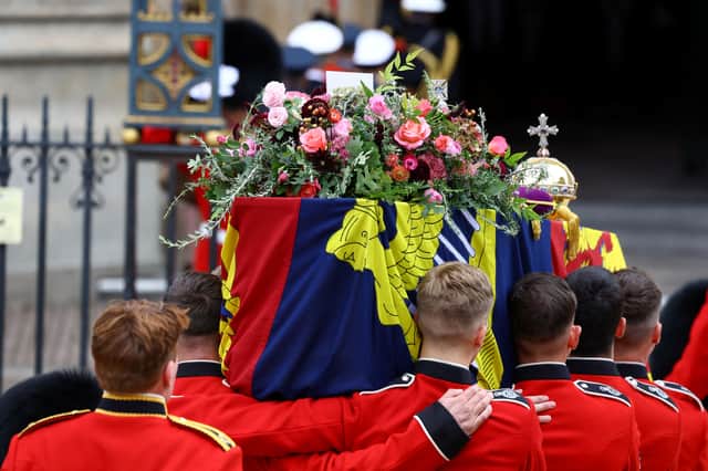 1st Battalion Grenadier Guards lifts the coffin of Queen Elizabeth II